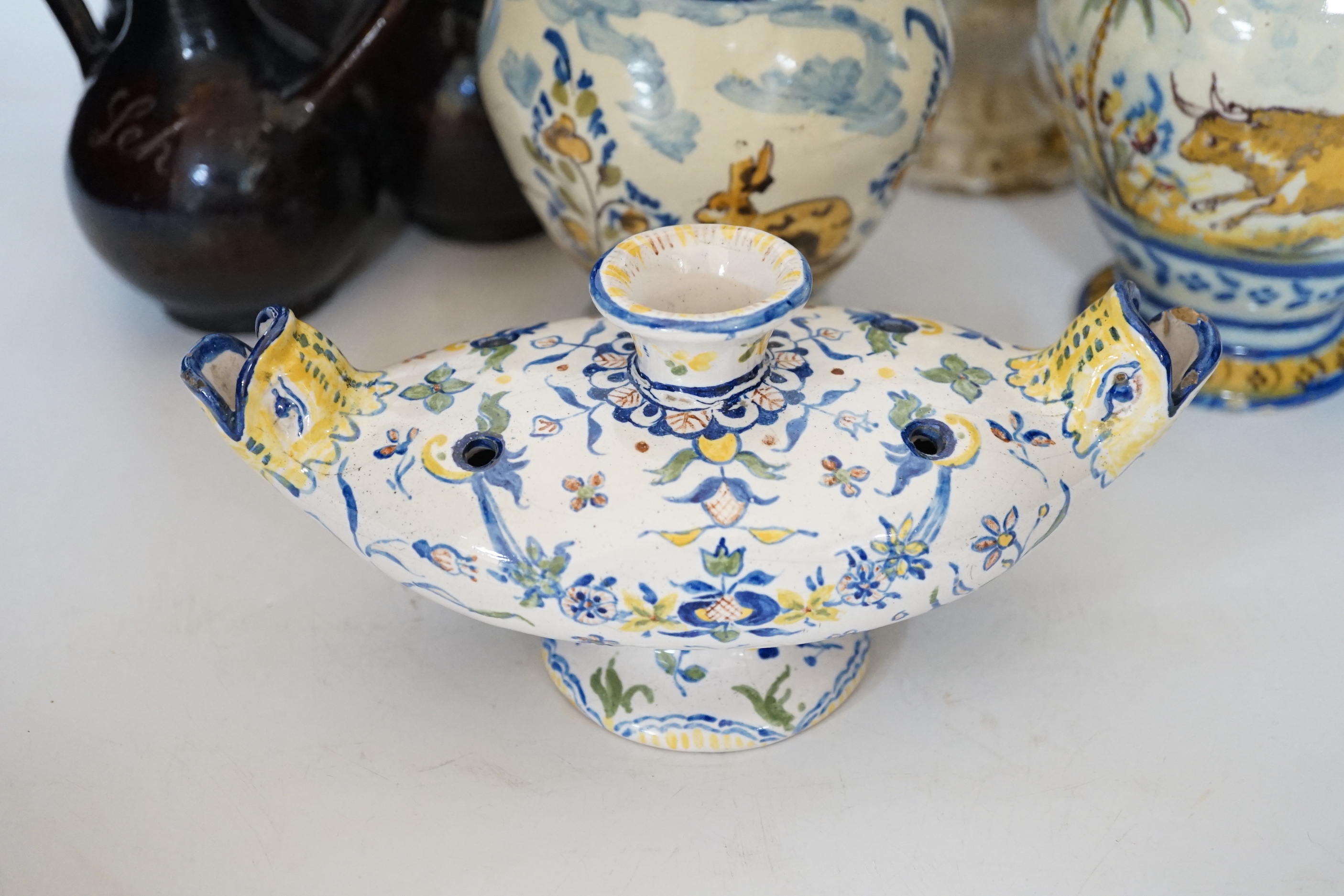 A Slavonic three section brown glazed earthenware puzzle jug and pair of 19th century Portuguese lizard handle maiolica vases and two other similar items, largest 28cm high